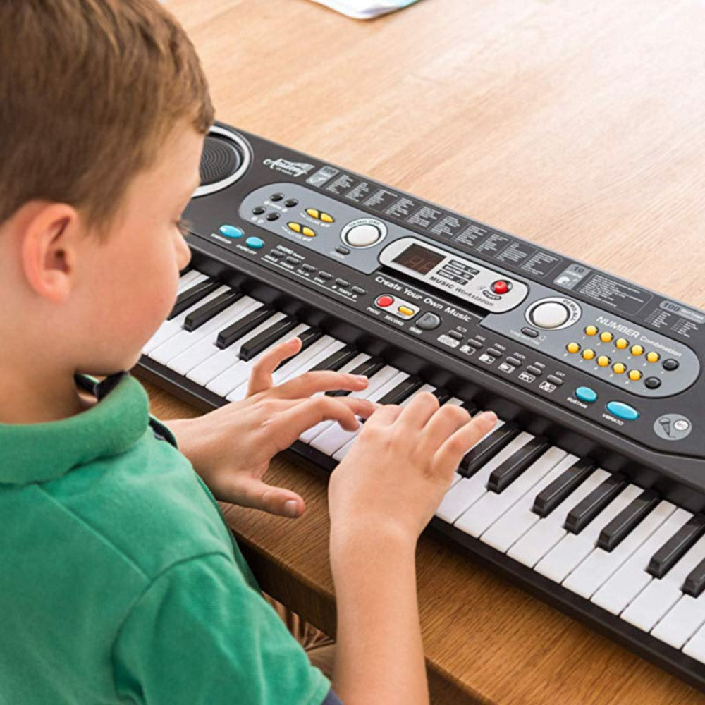 Child playing with the Academy of Music 54 Key Toy Electric Piano Keyboard for kids