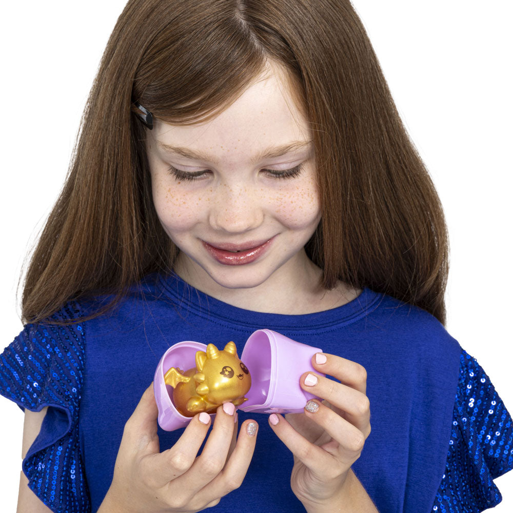 Girl opening a Aphmau Mystery MeeMeows Squishy Dragons fidget toys