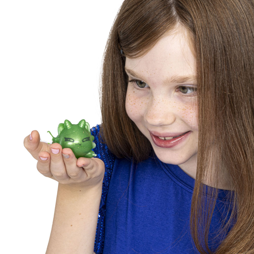 Girl holding a Aphmau Mystery MeeMeows Squishy Dragons fidget toys
