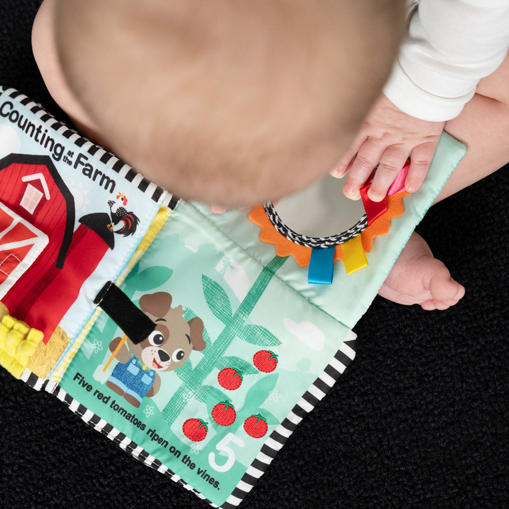 Baby playing with the Baby Einstein Counting At The Farm Soft Activity Book