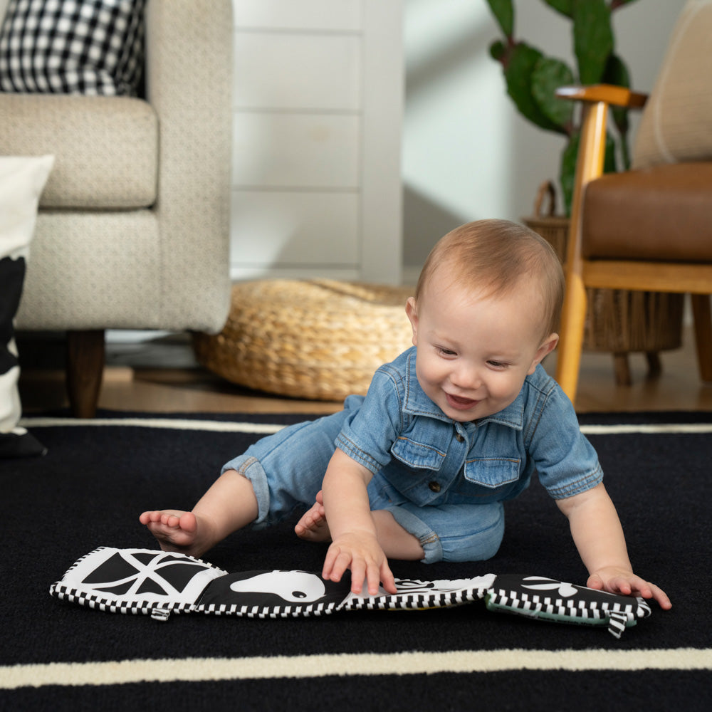 Baby playing with the Baby Einstein Counting At The Farm Soft Activity Book
