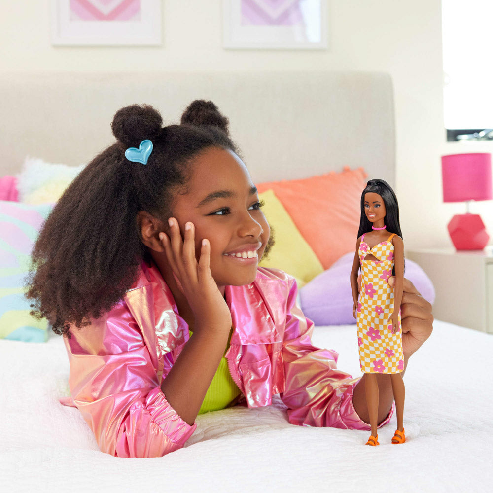 Child playing with the Barbie Fashionista Diversity Doll with Black Hair Skin - 233 Flower Midi Dress