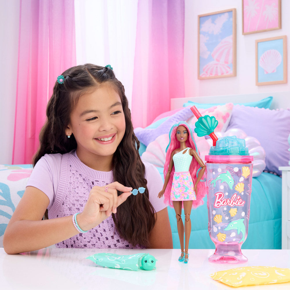 Child playing with the Barbie Pop Reveal Sea Slushy Doll - Dolphin