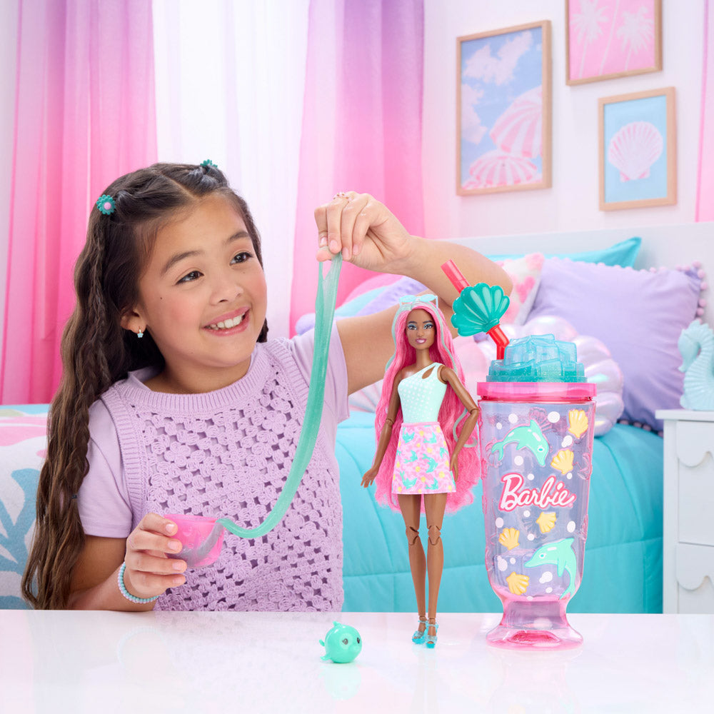 Child playing with the Barbie Pop Reveal Sea Slushy Doll - Dolphin