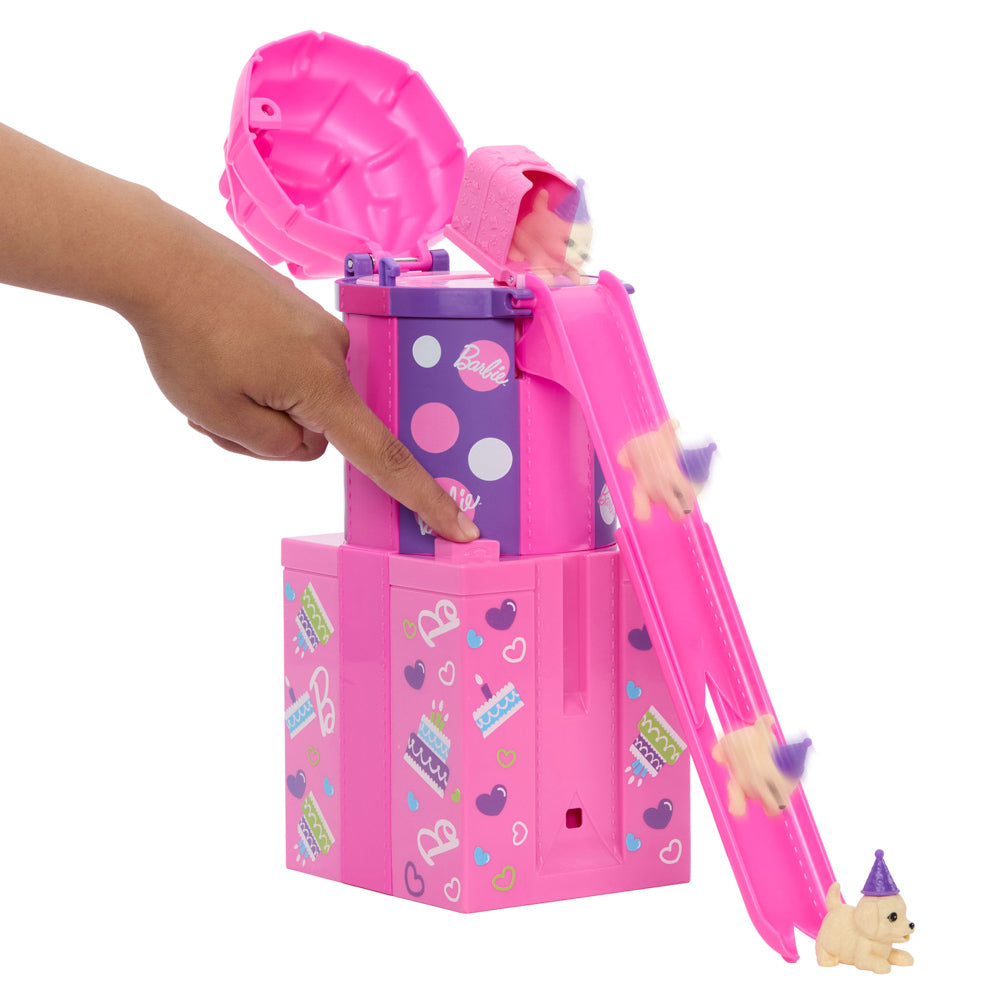 Puppy sliding down slide, in the Barbie Rise And Surprise Pet Birthday Doll with present to jump out of