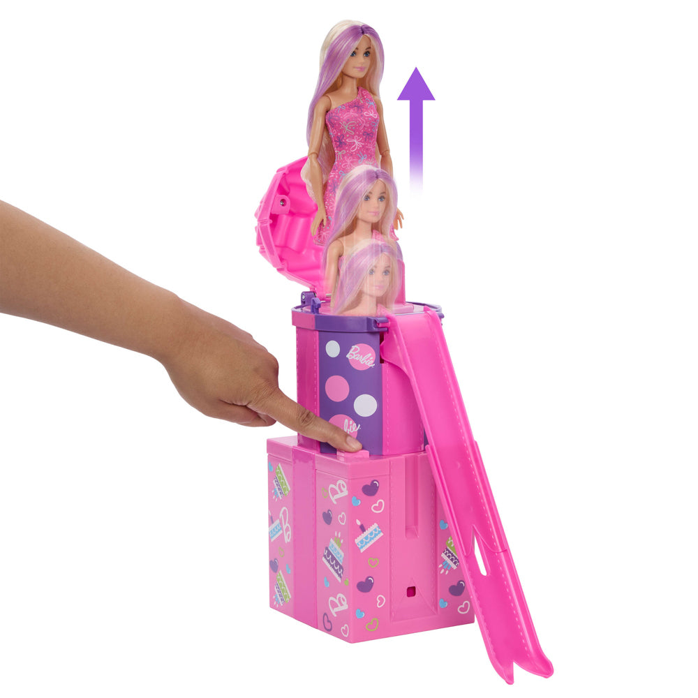 Barbie jumping out of present stack in the Barbie Rise And Surprise Pet Birthday playset