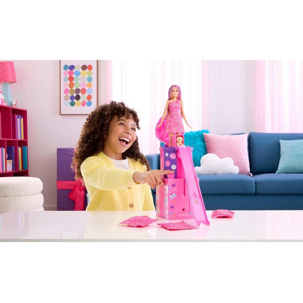 Child playing with the Barbie Rise And Surprise Pet Birthday Doll with present to jump out of