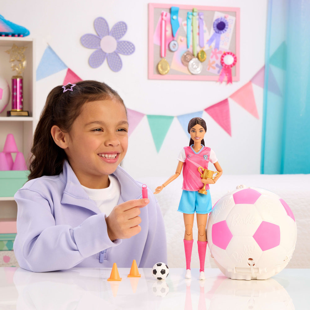 Child playing with the Barbie Team Roll and Reveal Soccer Ball and doll