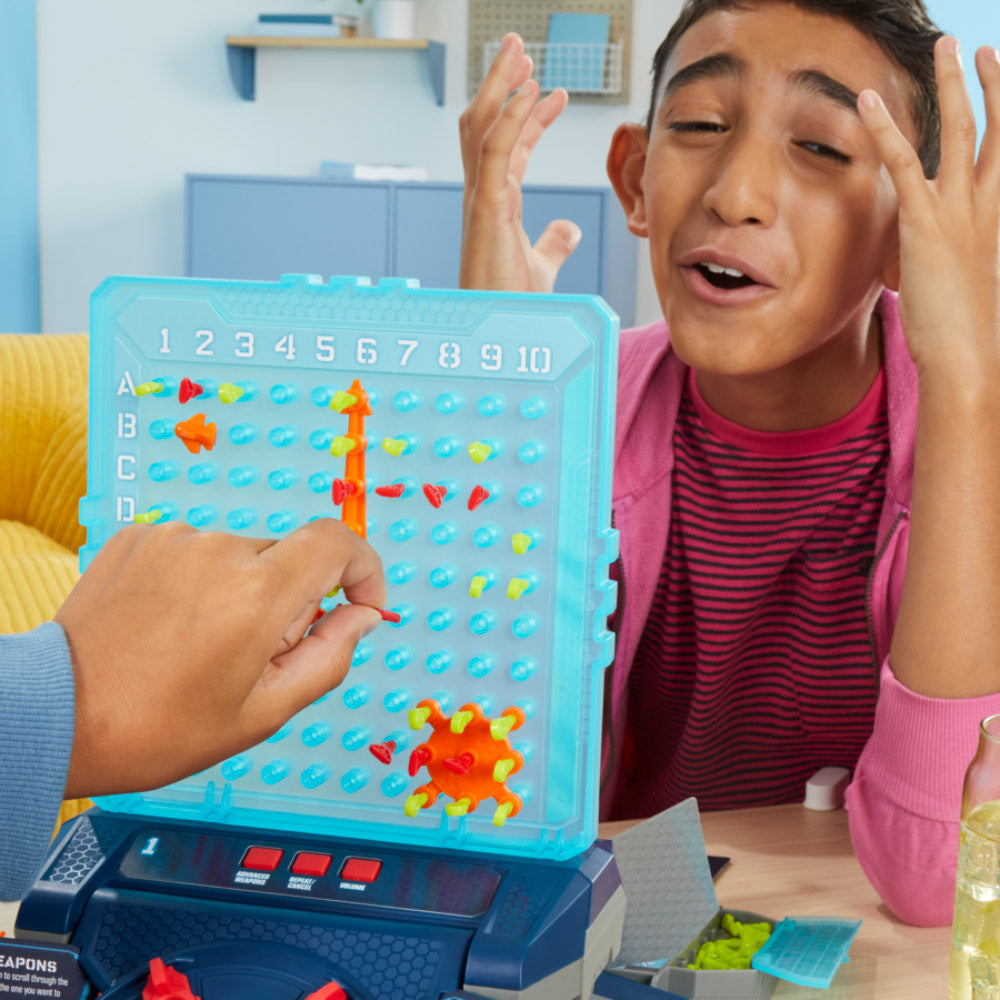 Children playing the Battleship Electronic Reloaded board game
