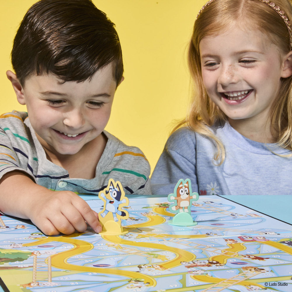 Children playing the Bluey Chutes & Ladders board game