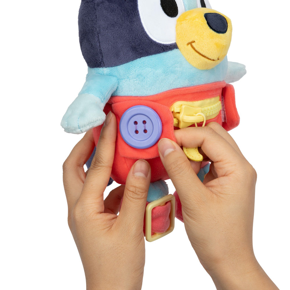 Learn how to dress, tie your shoes, buckle, zip, and use velcro, with Bluey Dress & Play plush.
