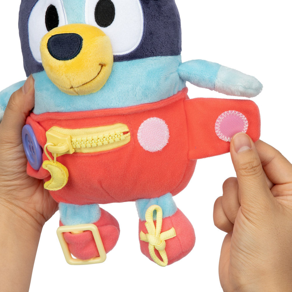 Learn how to dress, tie your shoes, buckle, zip, and use velcro, with Bluey Dress & Play plush.
