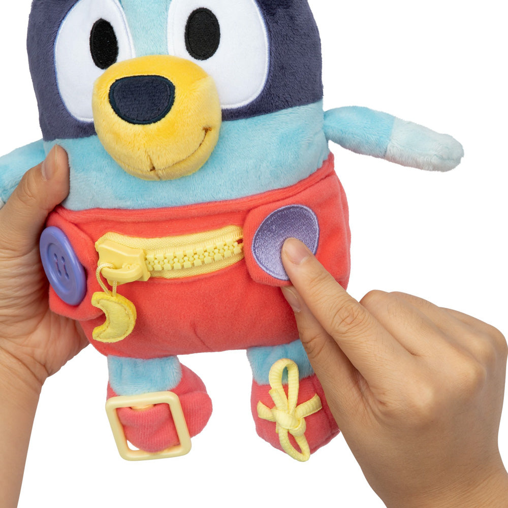Learn how to dress, tie your shoes, buckle, zip, and use velcro, with Bluey Dress & Play plush.