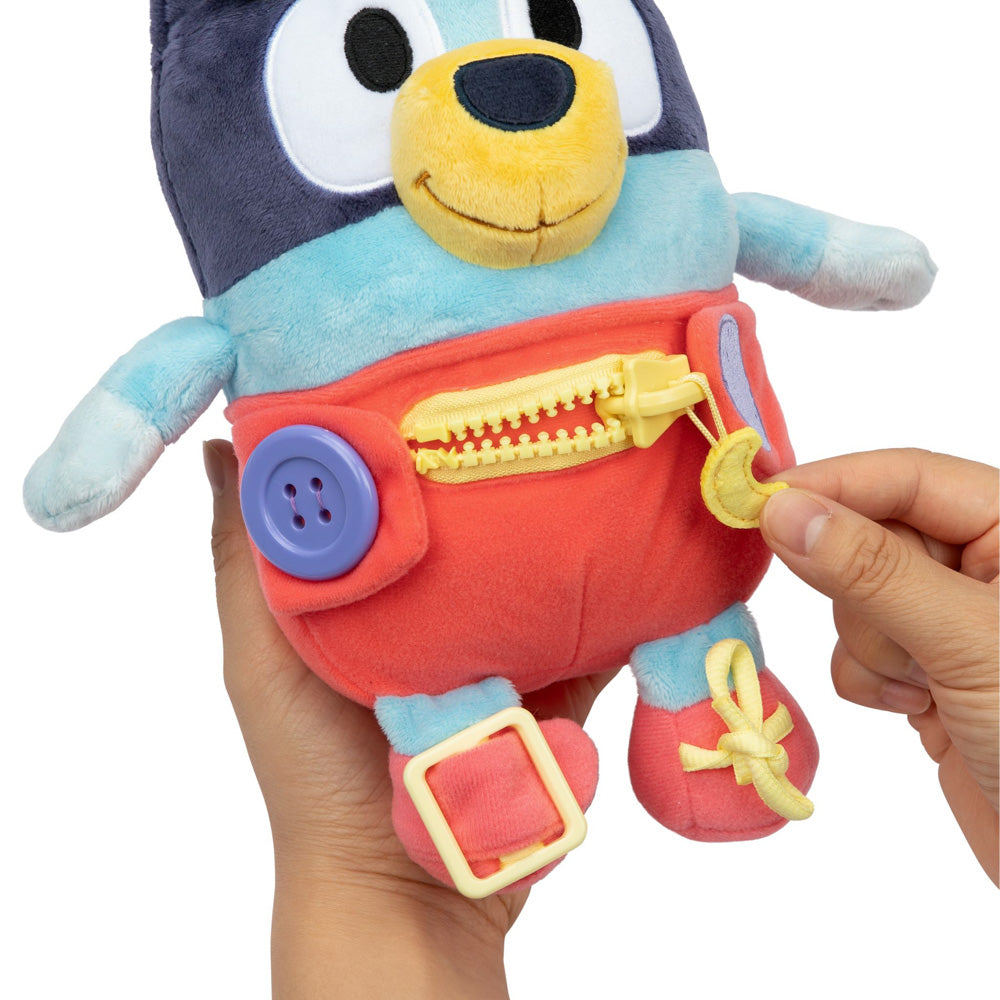 Learn how to dress, tie your shoes, buckle, zip, and use velcro, with Bluey Dress & Play plush.