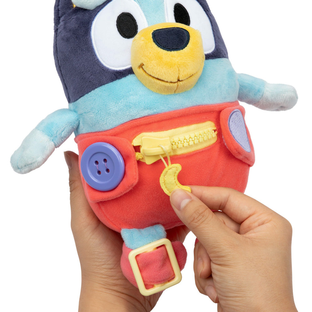 Learn how to dress, tie your shoes, buckle, zip, and use velcro, with Bluey Dress & Play plush.