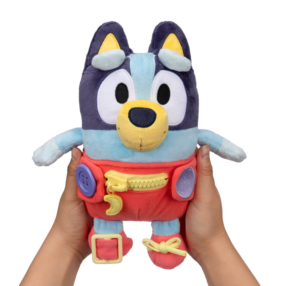 Learn how to dress, tie your shoes, buckle, zip, and use velcro, with Bluey Dress & Play plush.