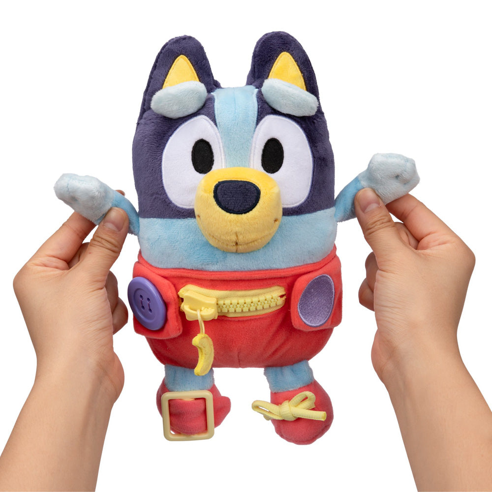 Learn how to dress, tie your shoes, buckle, zip, and use velcro, with Bluey Dress & Play plush.