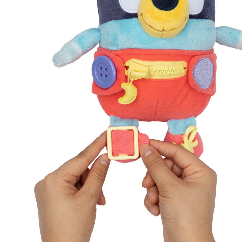 Learn how to dress, tie your shoes, buckle, zip, and use velcro, with Bluey Dress & Play plush.