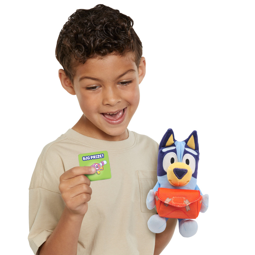 Child playing with the Bluey Pass The Parcel Musical Game with plush soft toy