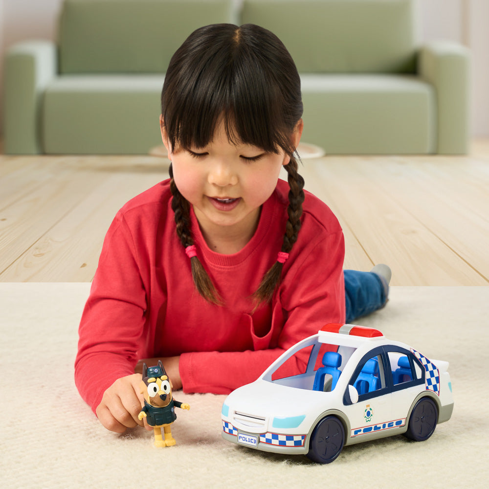 Child playing with the Bluey Police Car toy with figure