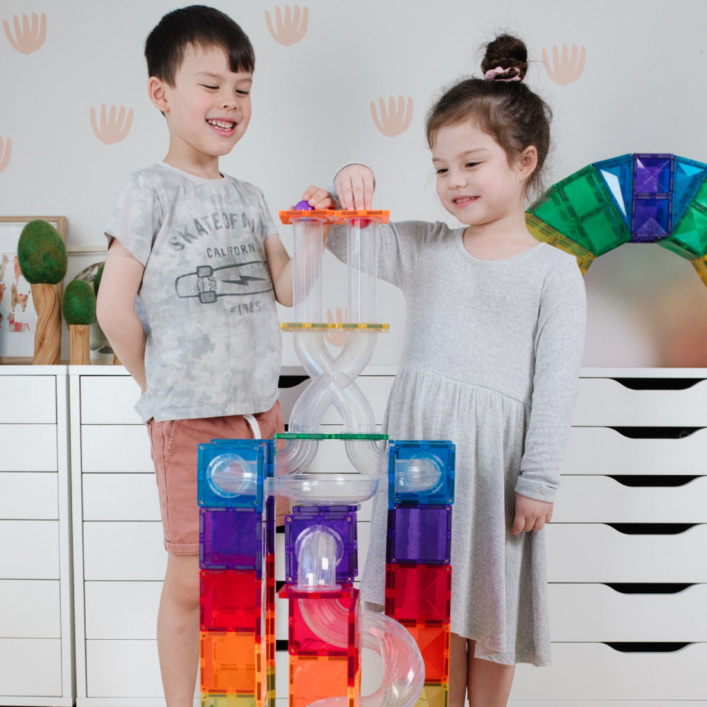 Children playing with the CONNETIX Magnetic Tiles 66 Piece - Rainbow Ball Run Expansion Pack