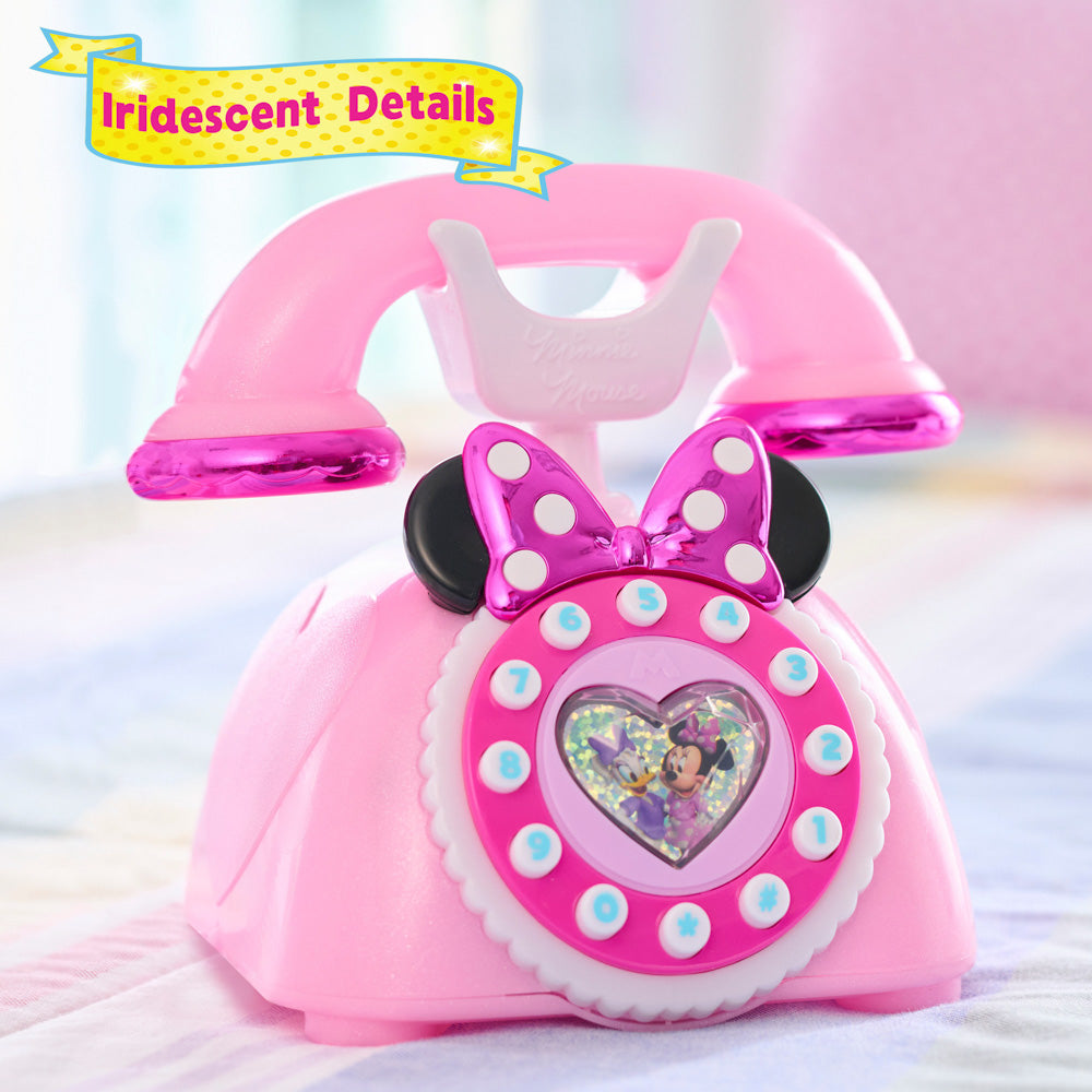 Pink Disney Junior Minnie Mouse Ring Me Rotary Play Phone on a bed