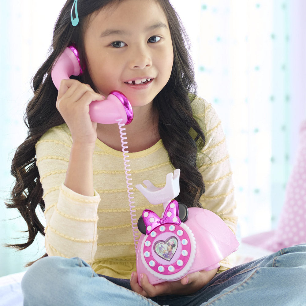 Child talking on the Disney Junior Minnie Mouse Ring Me Rotary Play Phone