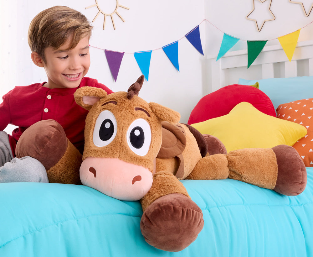 Child cuddling with Disney Pixar Toy Story 5 Ginormous Bullseye horse Plush soft toy