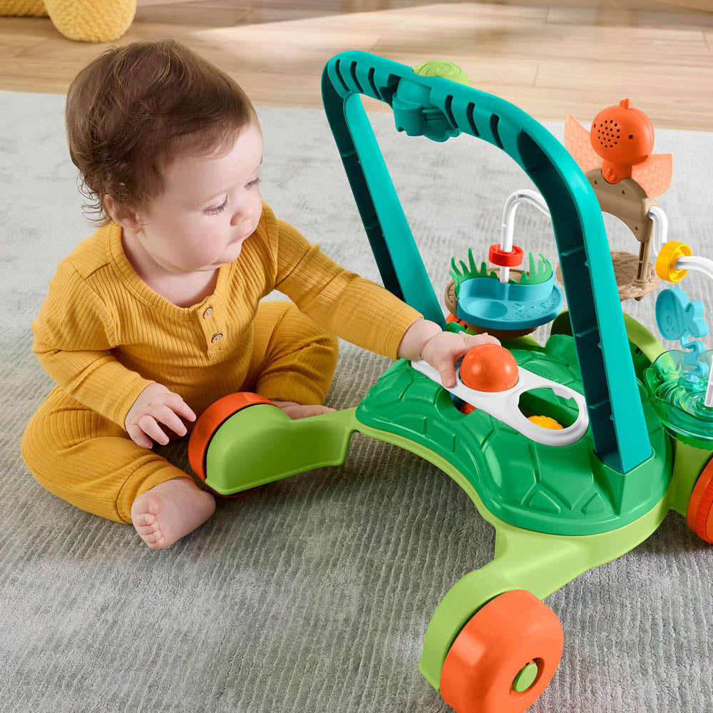 Baby playing wth the rattle balls on the Fisher-Price Turtle Walker.