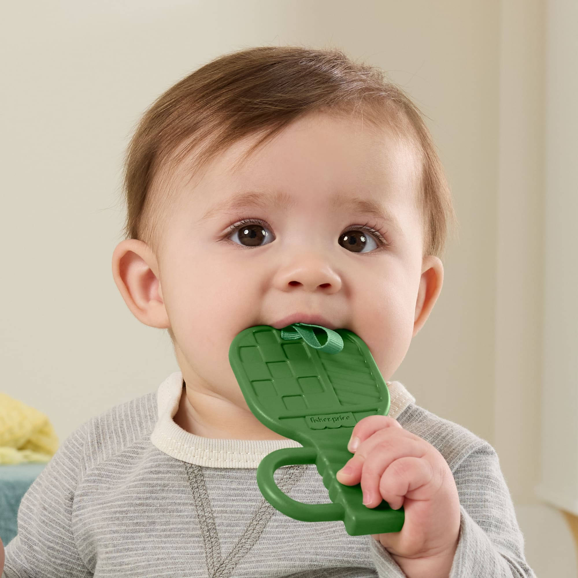 Baby playing with the Fisher-Price Mini Me Moments Let's Play Pickleball toy