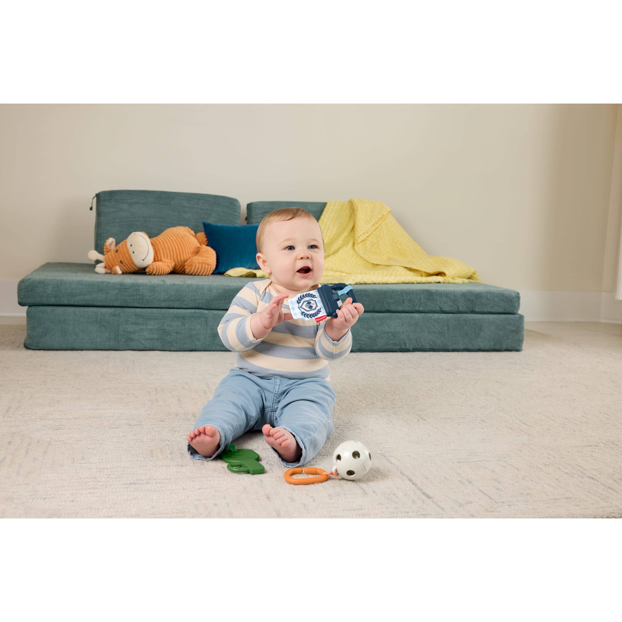 Baby playing with the Fisher-Price Mini Me Moments Let's Play Pickleball toy