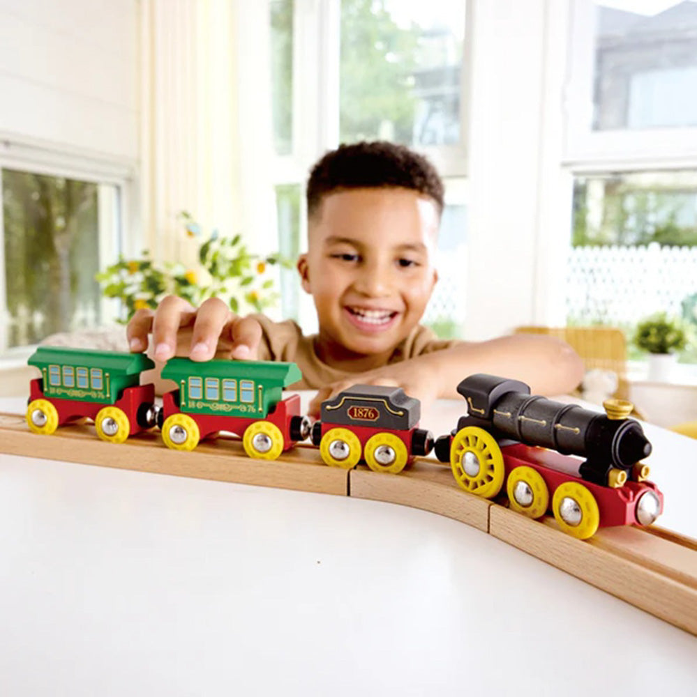 Child playing with the Hape Wooden Retro Steam Train with Lights & Sounds