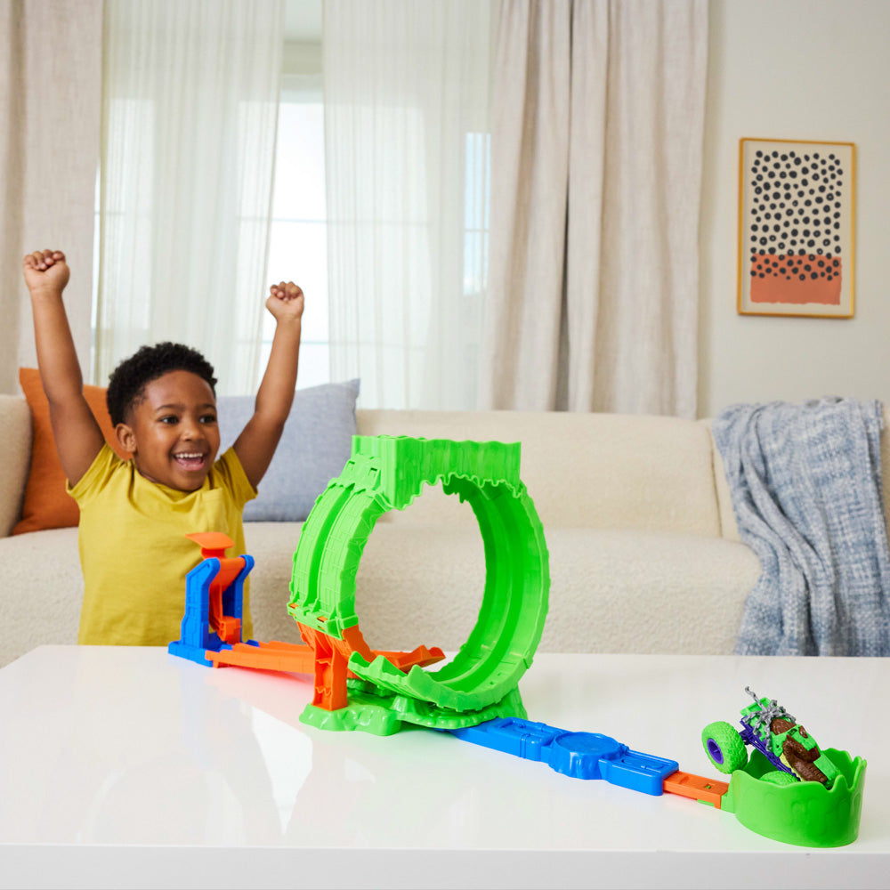 Child playing with the Hot Wheel Monster Trucks Mutant Chaos Loop Challenge playset.