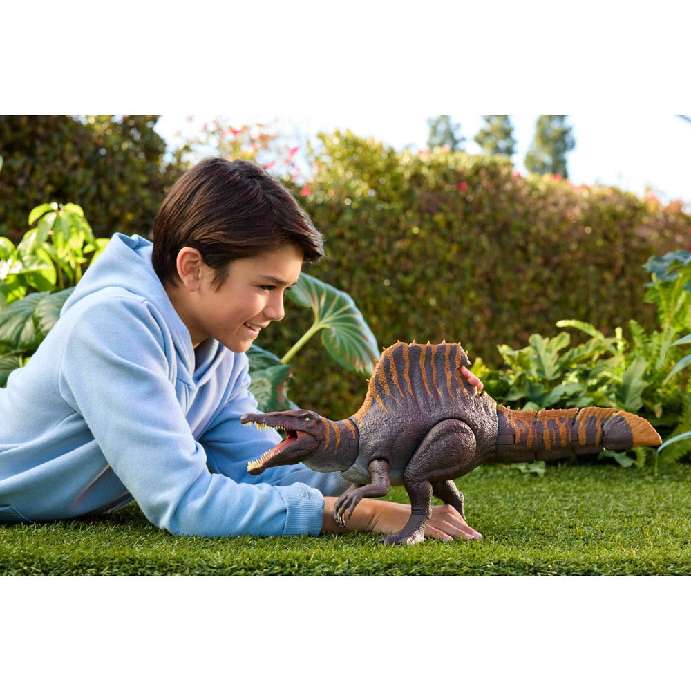 Child playing with the Jurassic World Rebirth Tail Thrasher Spinosaurus dinosaur toy