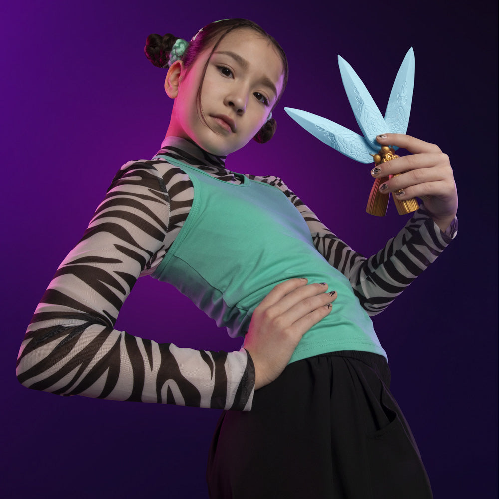 Girl posing with the KPop Demon Hunters Zoey's Spirit Blade toys