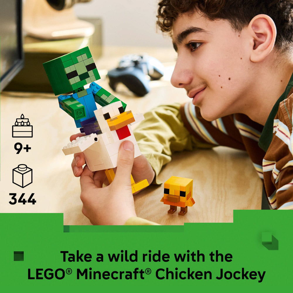 Boy holding the assembled LEGO 21582 Minecraft Chicken Jockey set