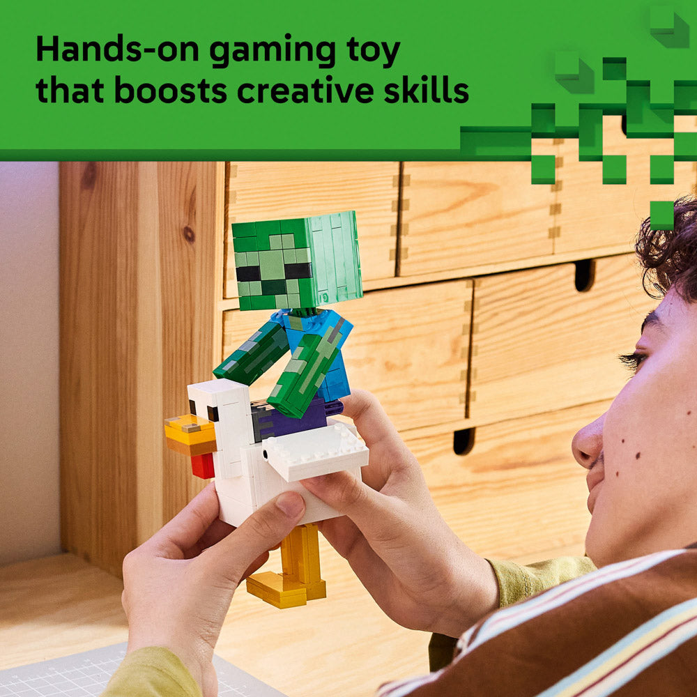 Boy holding the assembled LEGO 21582 Minecraft Chicken Jockey set