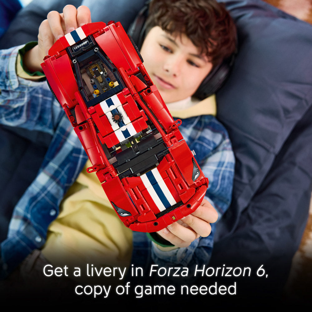 Boy holding the assembled LEGO 42235 Technic Ferrari 488 Pista Car set.