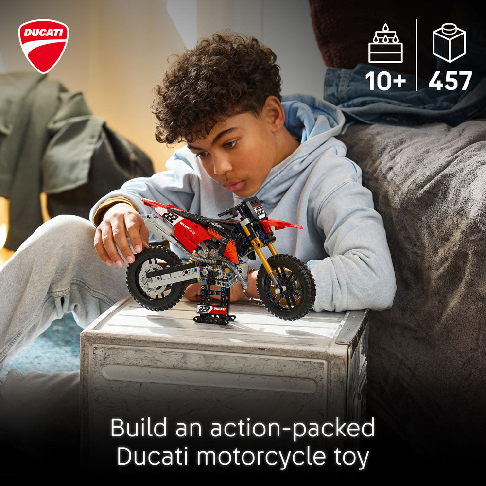 Boy building the LEGO 42238 Technic Ducati Desmo450 MX Factory Motorcycle set