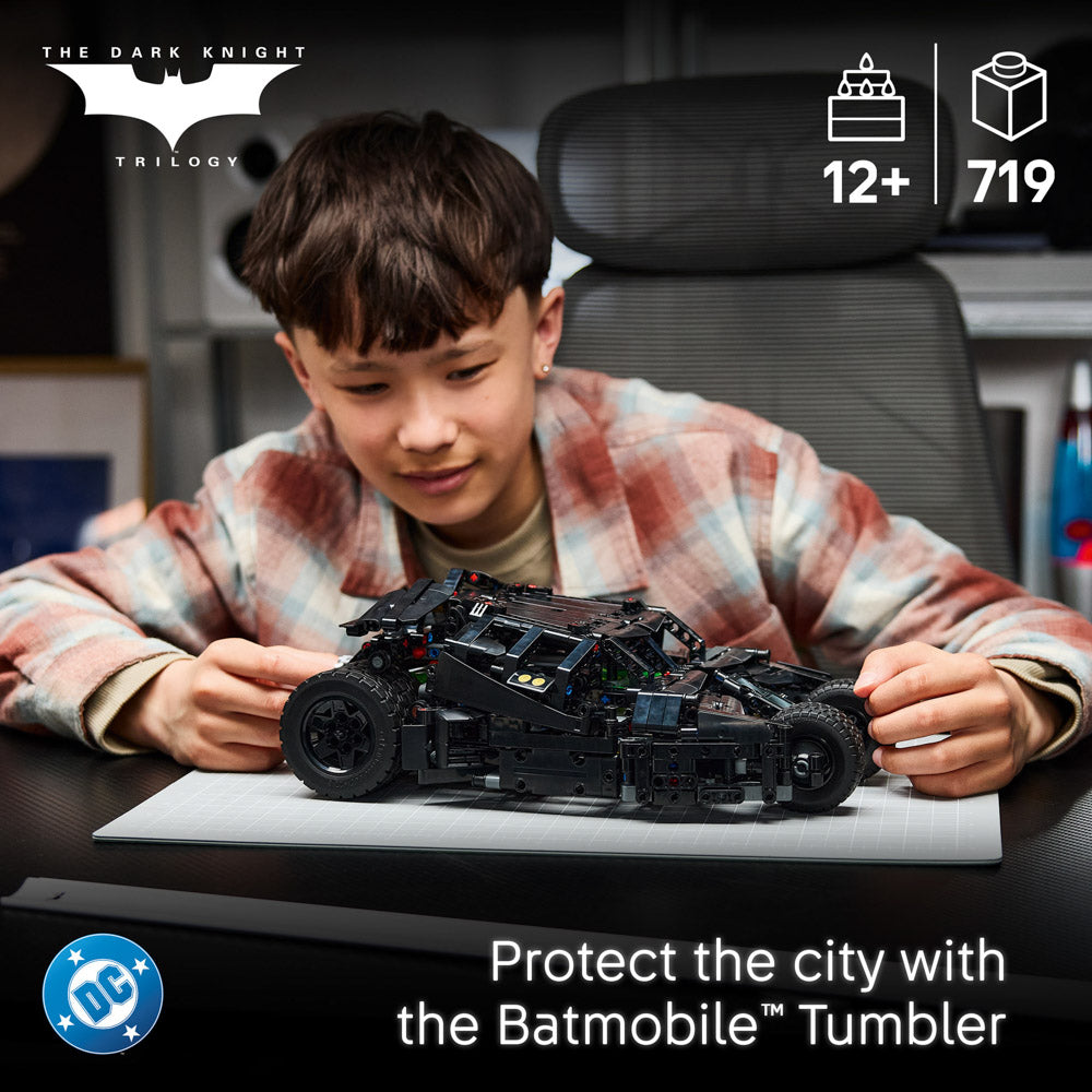 Boy building the LEGO 42239 Technic Batman Batmobile Tumbler Car set with remote-control function.
