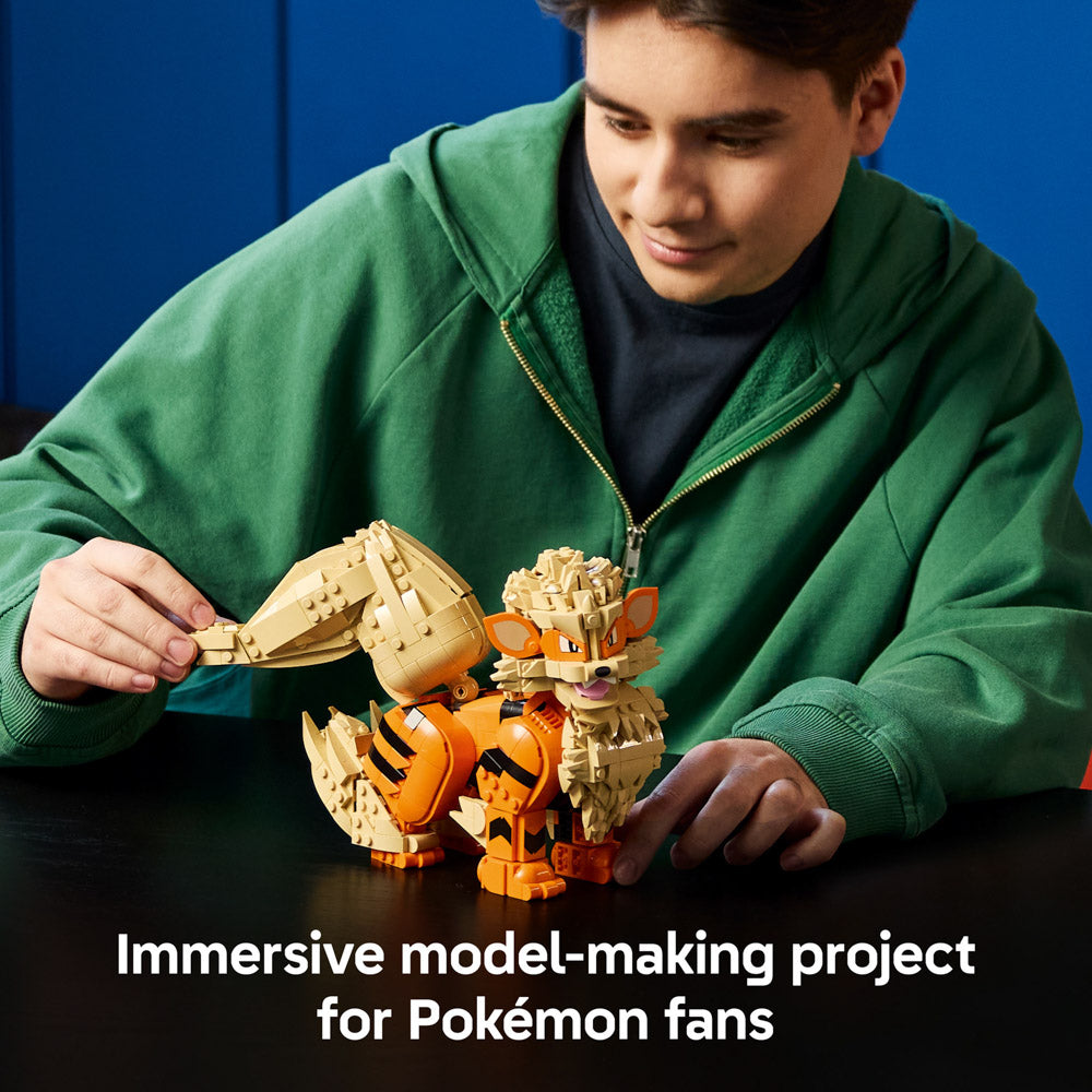 Man holding the assembled LEGO 72160 Pokémon Arcanine set for Adults