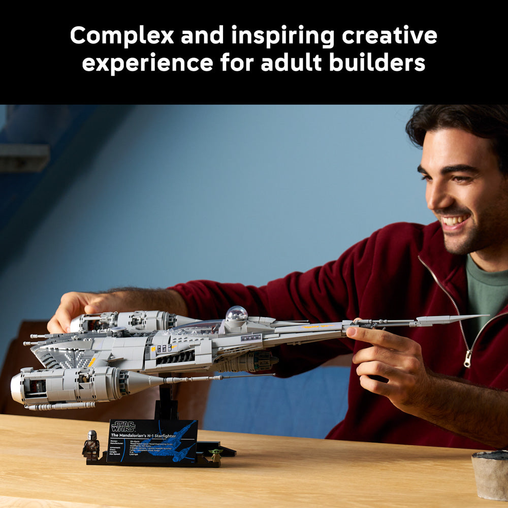 Man admiring the assembled LEGO 75442 Star Wars The Mandalorian's N-1 Starfighter set