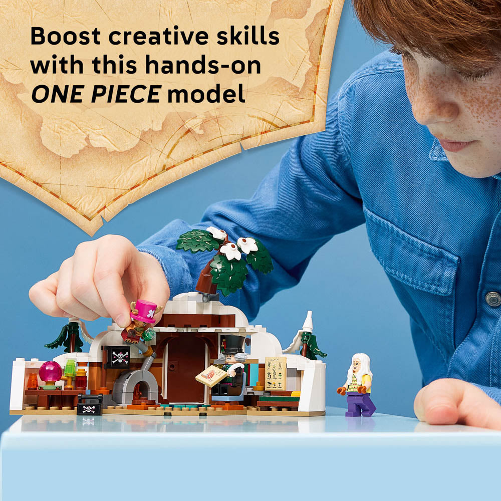 Boy playing with the Assembled LEGO 75641 ONE PIECE Dr. Hiriluk's Hideout diorama set