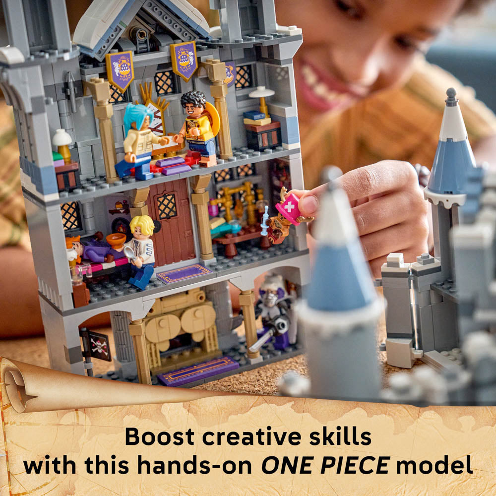 Boy playing with the assembled LEGO 75645 ONE PIECE Battle at Drum Castle set