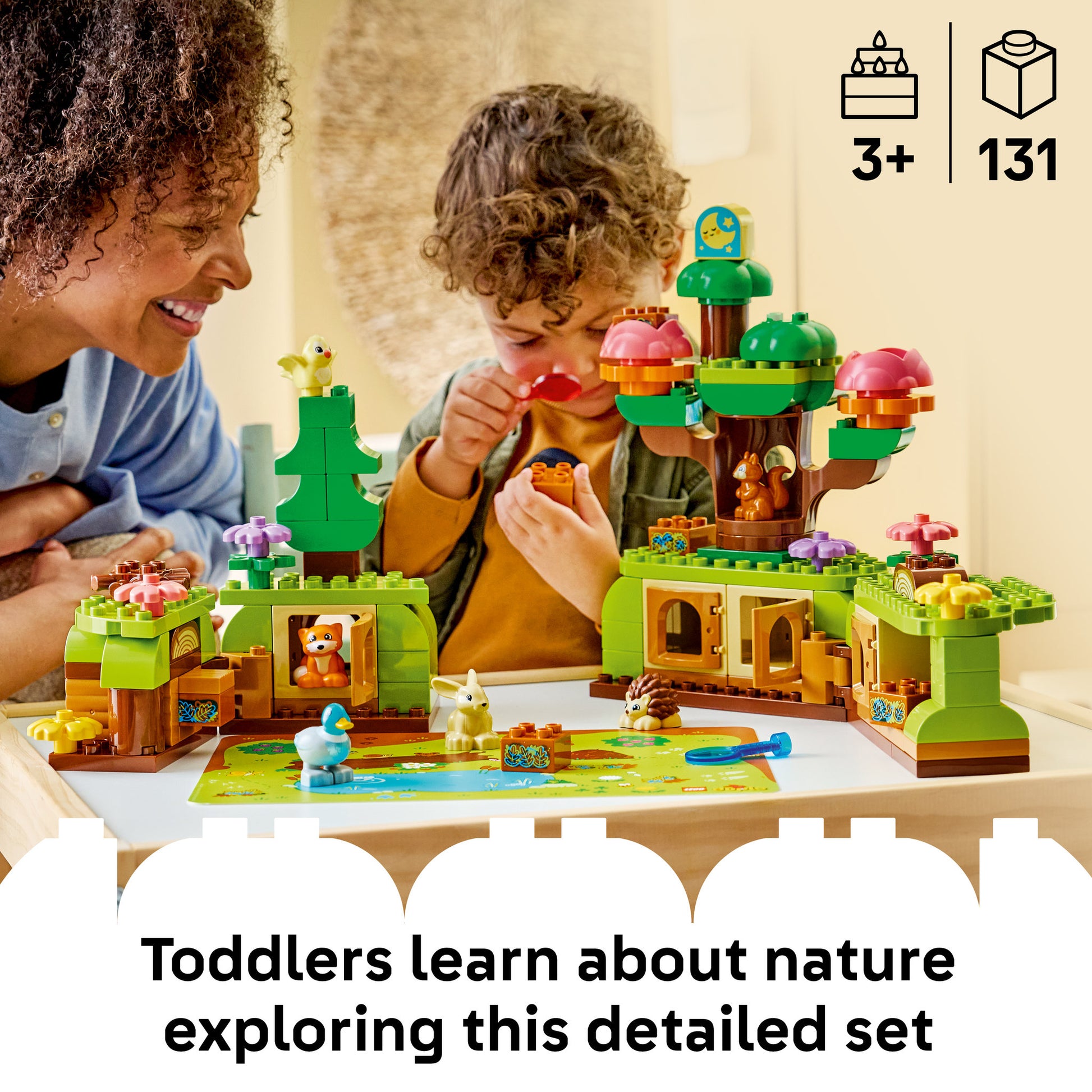 Toddler building the LEGO 10480 DUPLO Town Discovery Forest with Wild Animals Set