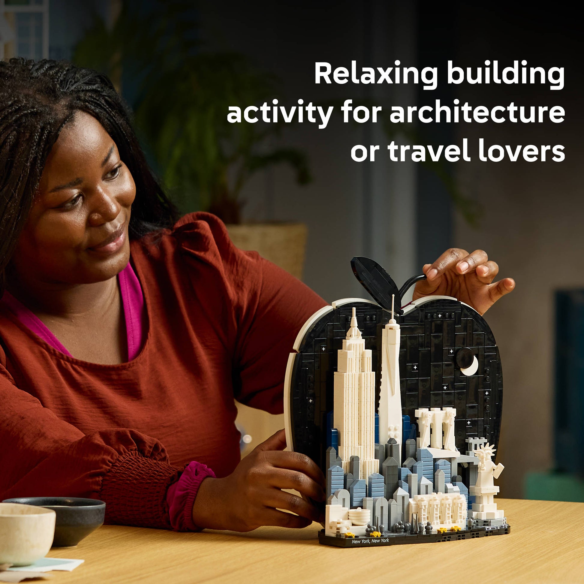 Adult building the LEGO 21066 Architecture New York City The Big Apple Set