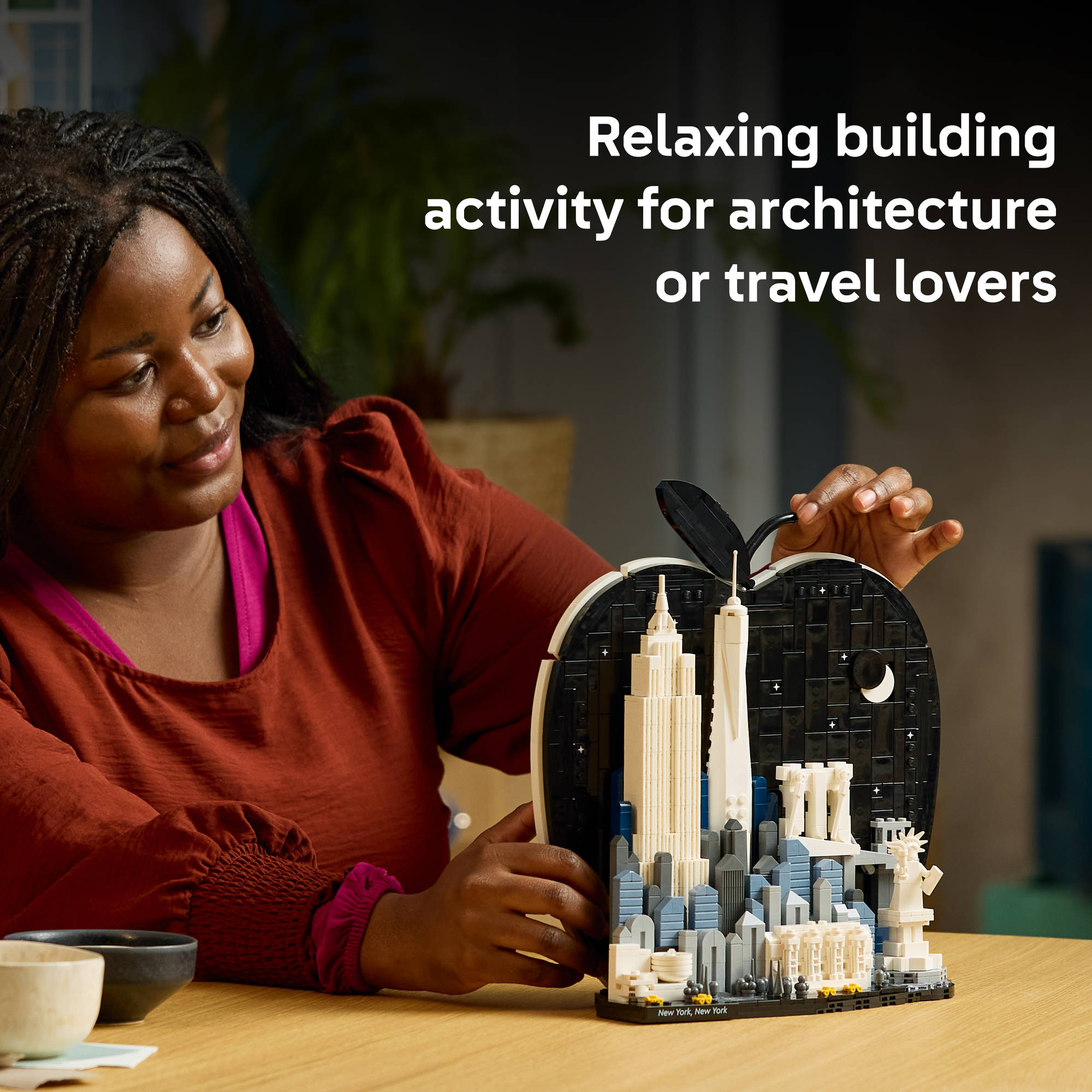 Adult building the LEGO 21066 Architecture New York City The Big Apple Set