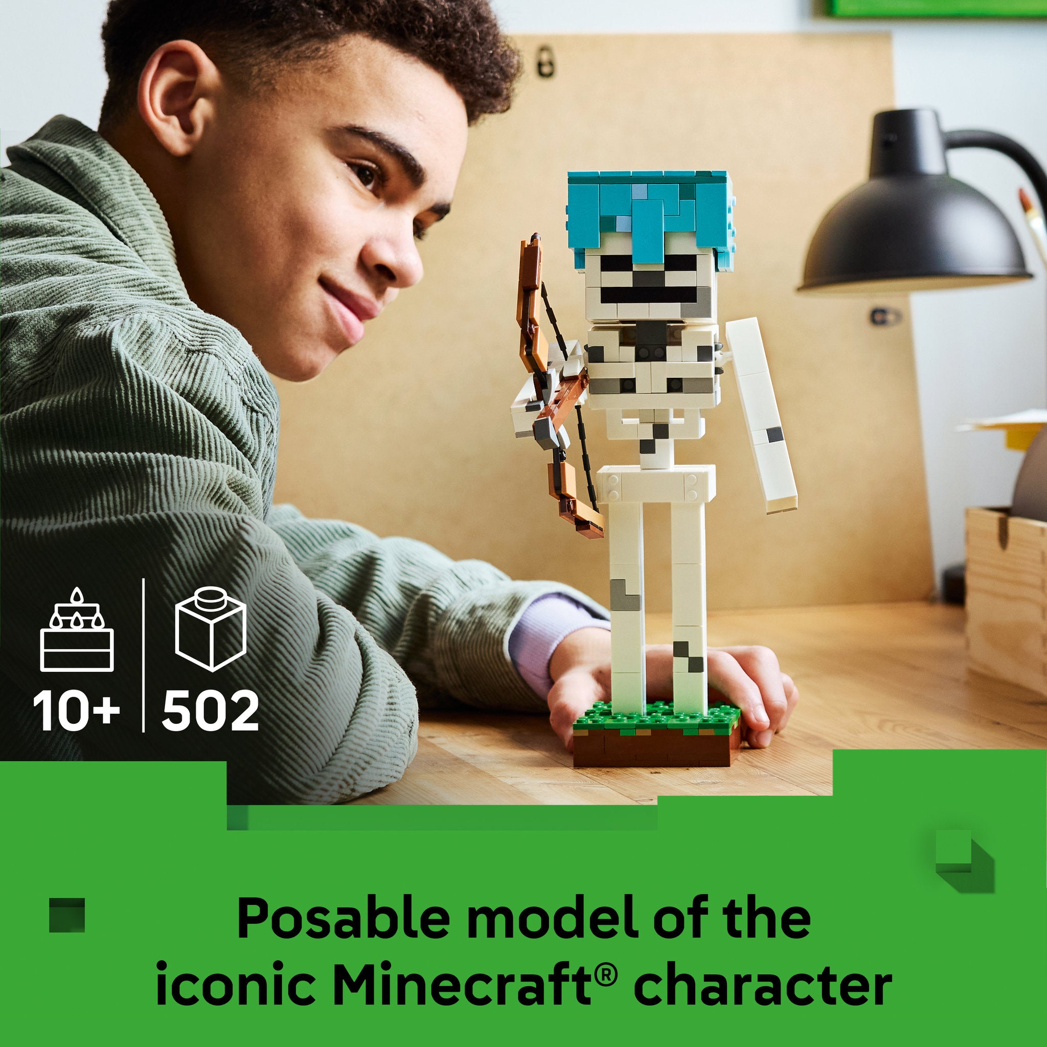 Teenager posing the assembled LEGO 21594 Minecraft The Skeleton Set
