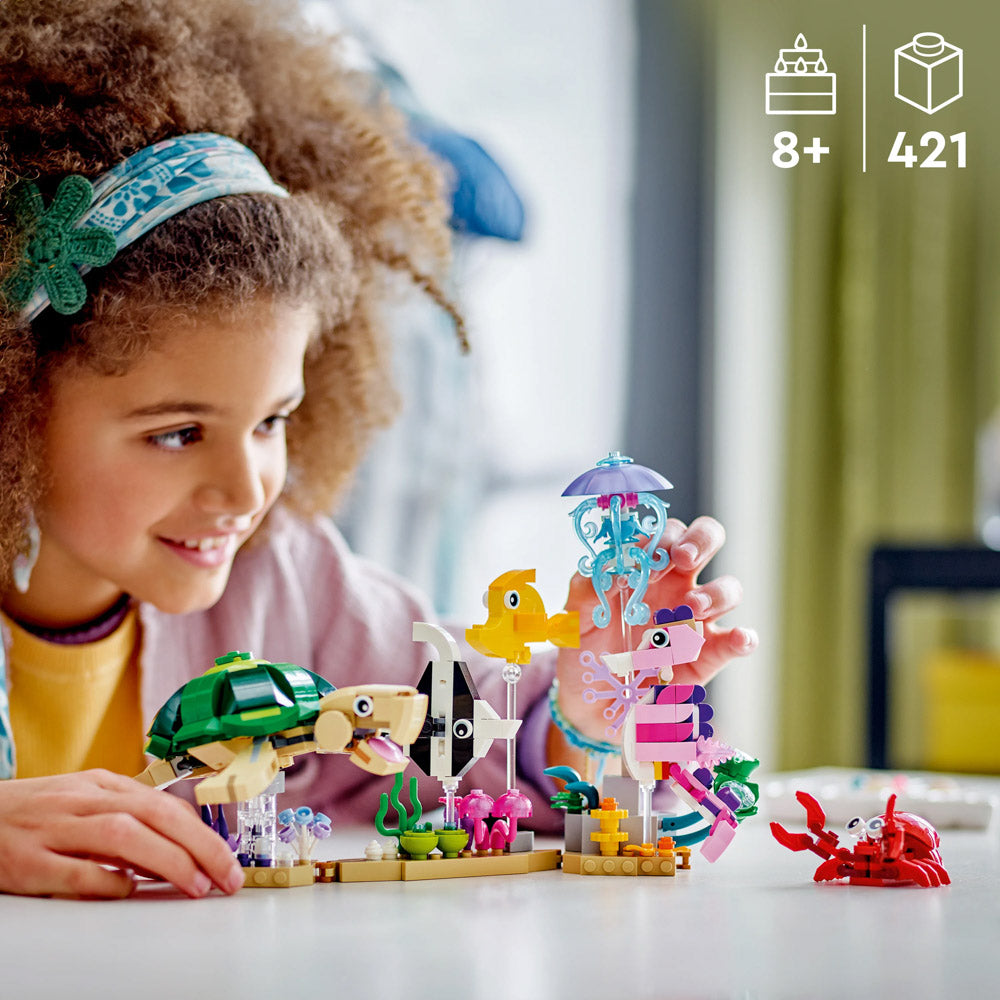 Child playing with the LEGO 31158 Creator Sea Animals set