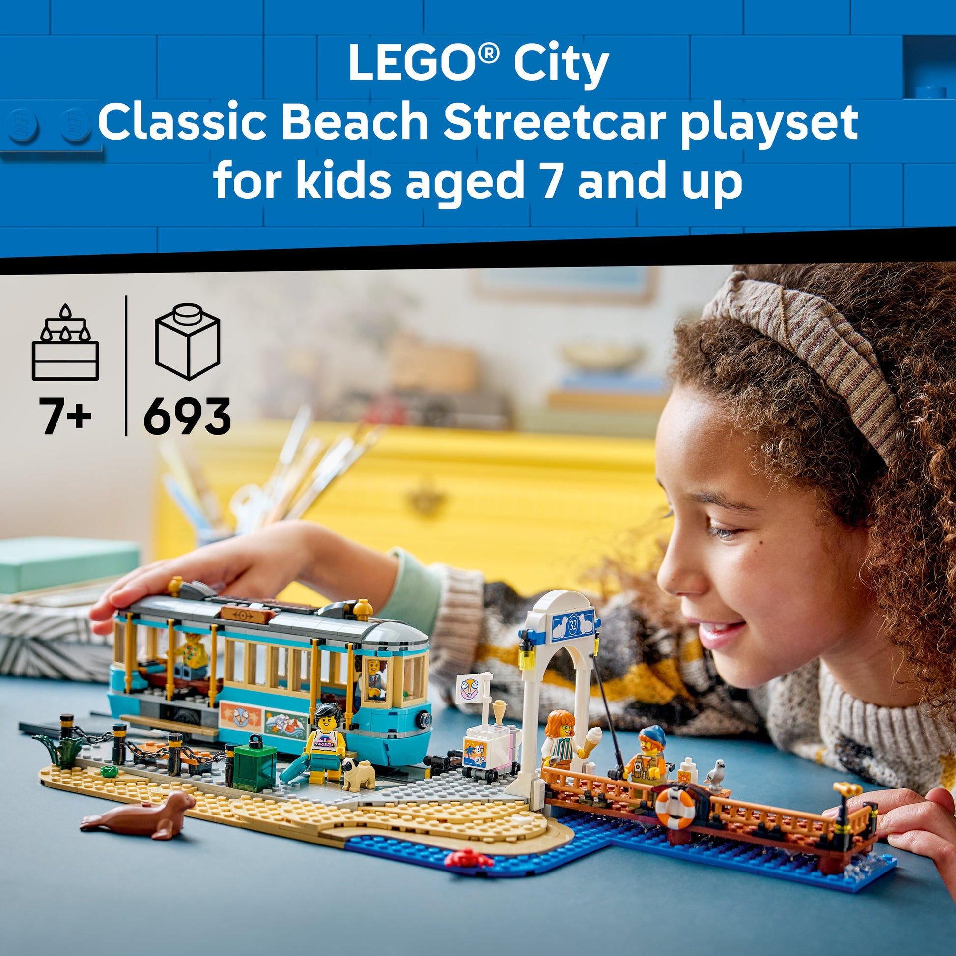 Child playing with the LEGO 60506 City Classic Beach Streetcar Set